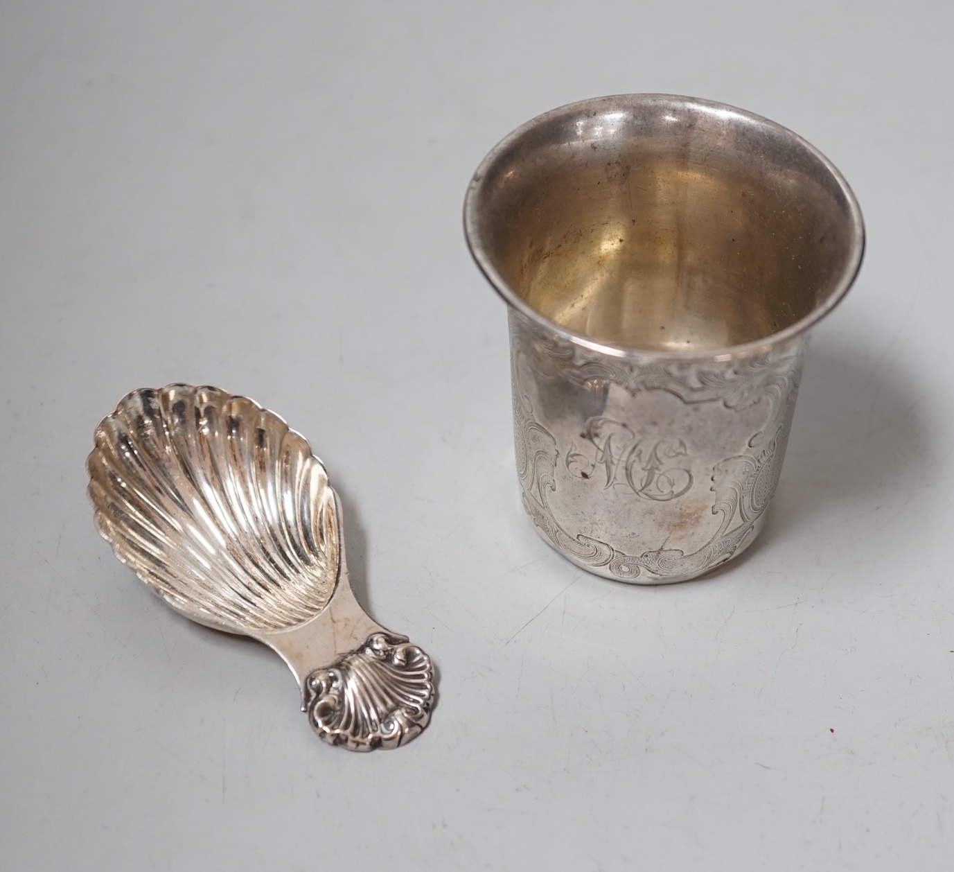 A Continental white metal tumbler cup, 66mm and a Mappin & Webb plated caddy spoon